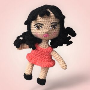 Charmante poupée au crochet avec une robe saumon.
